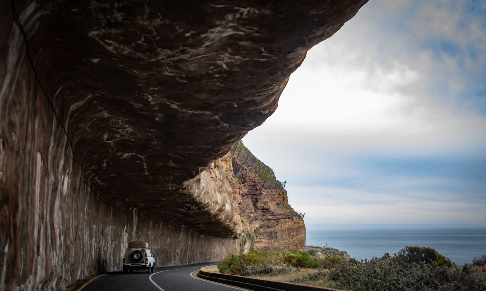 SUV driving along Chapman's Peak in Cape Town