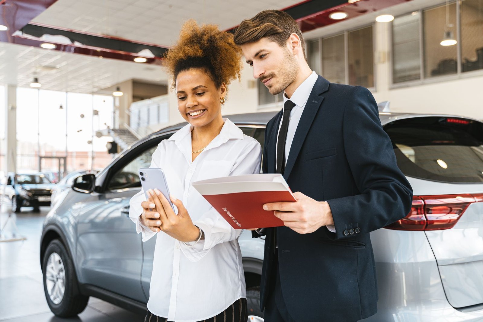 Dealership advisor reviewing vehicle information with a customer