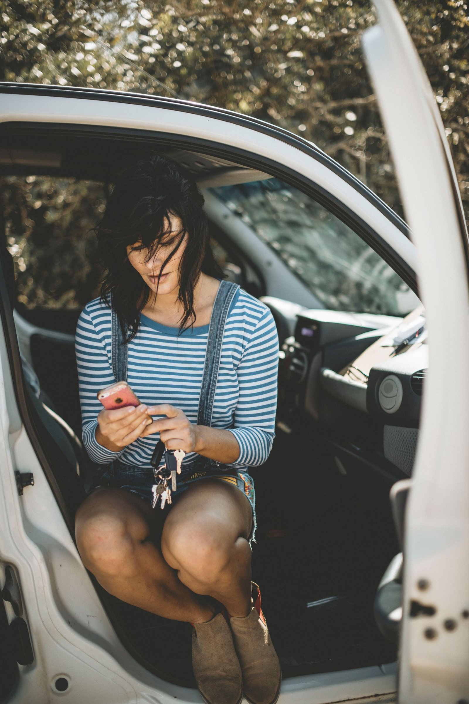 Vehicle owner using her phone during a road trip