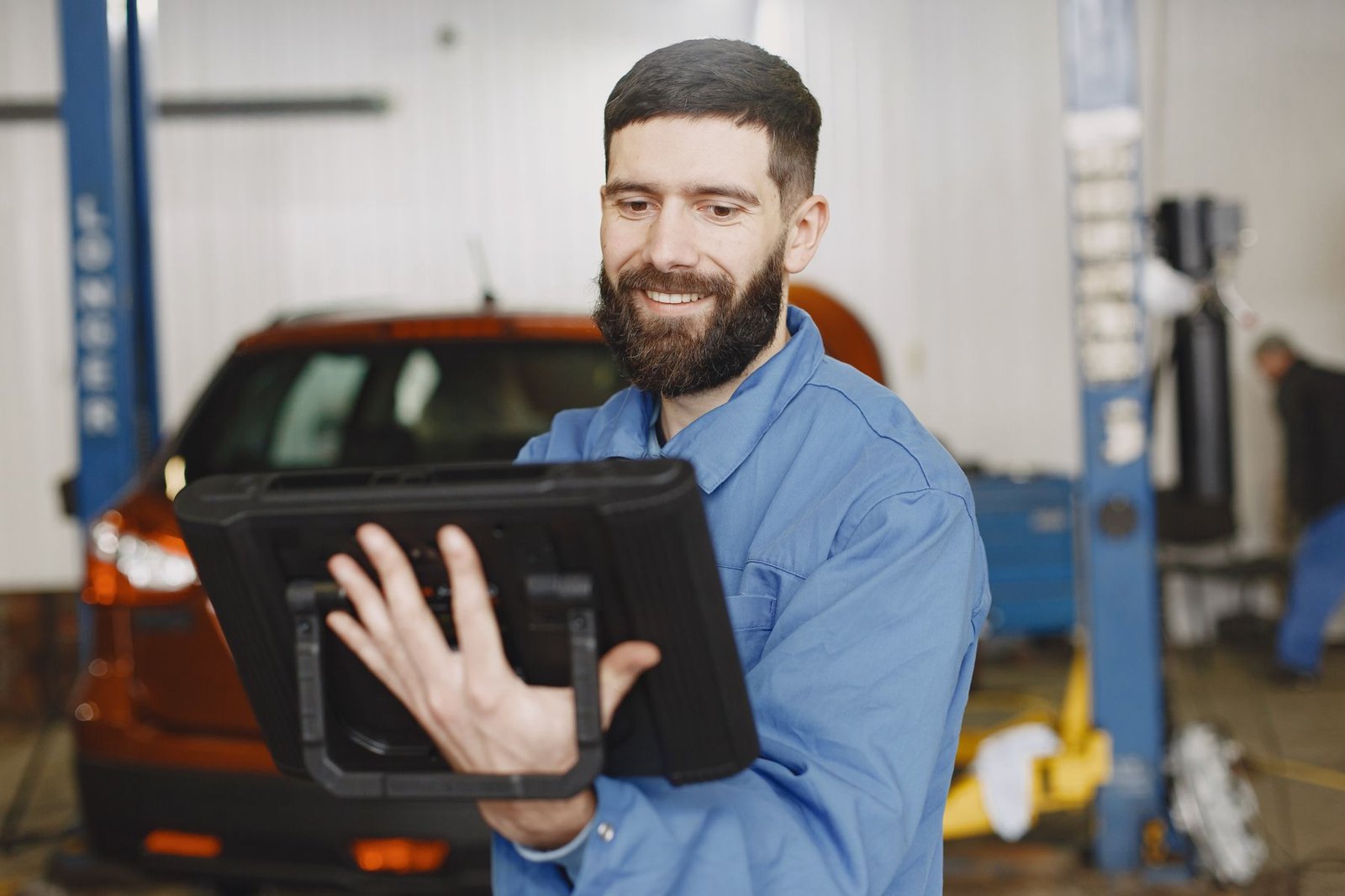 Professional technician reviewing vehicle diagnostics on a tablet